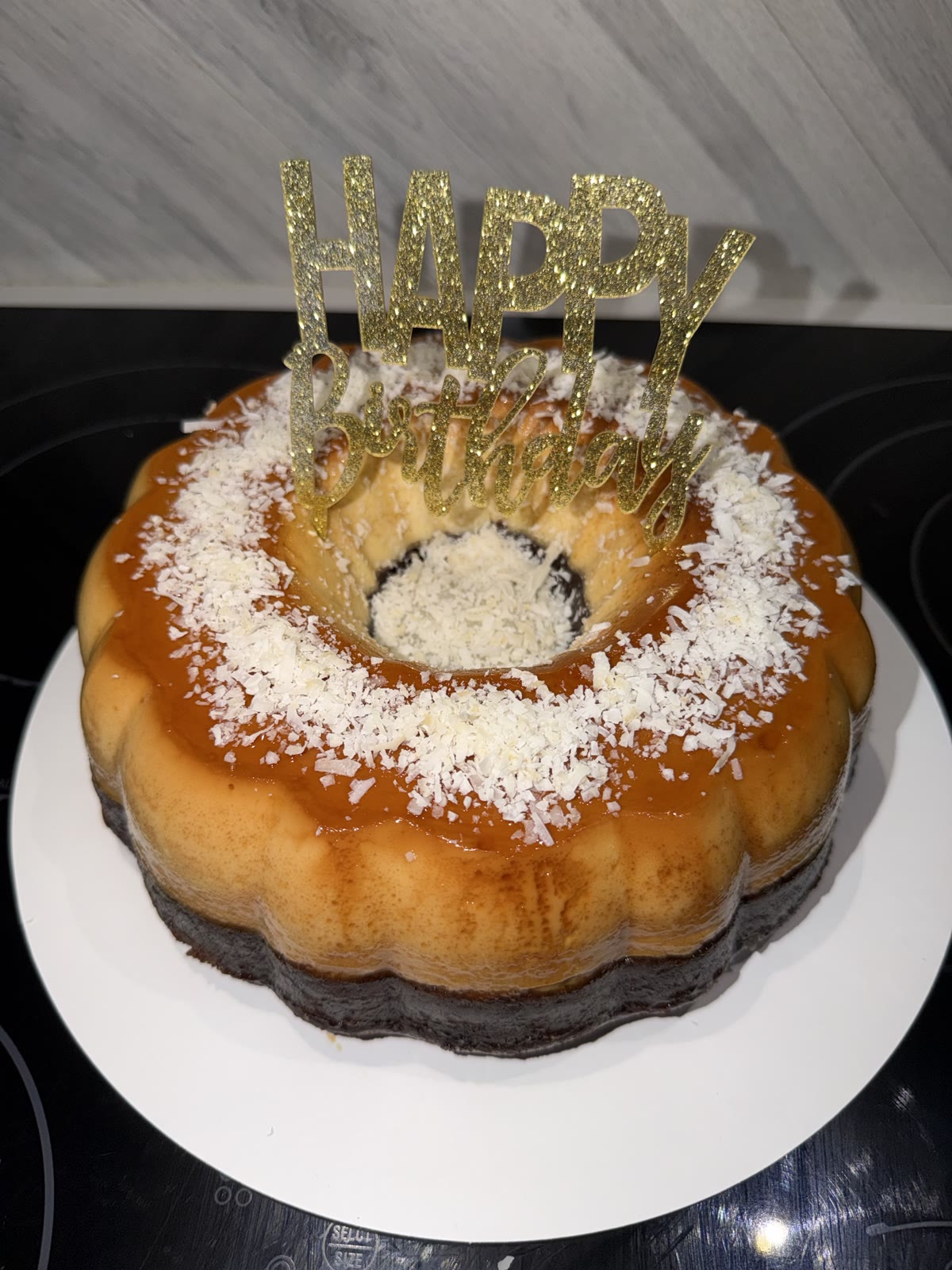 Coconut-topped ring chocoflan with a birthday topper