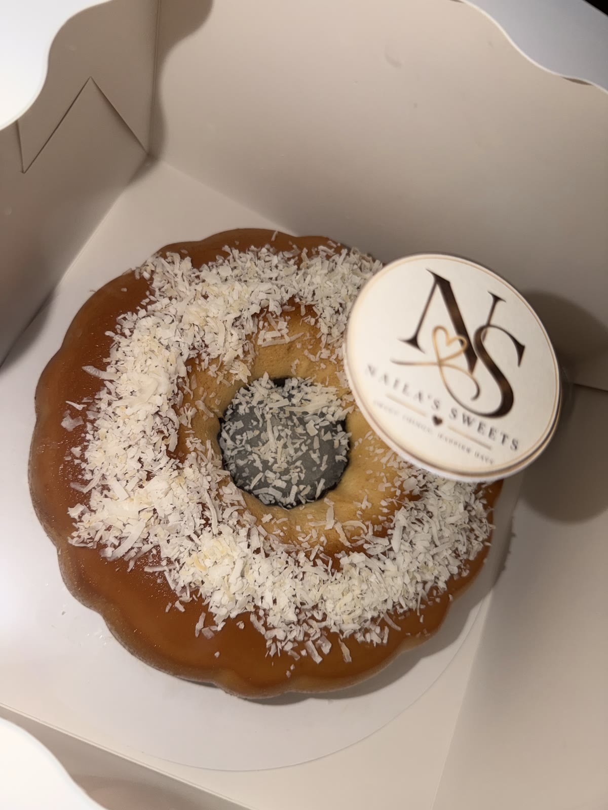 Coconut-topped chocoflan with a Naila’s Sweets brand topper
